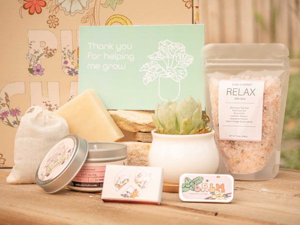 Thank you for helping me grow Succulent Gift Box with relax bath salt, natural soap, candle, custom matches, lavender sachet and lip balm, in front of a decorative gift box