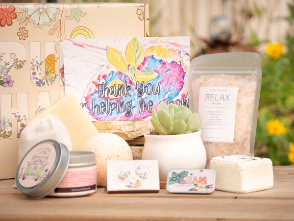 Thank you for helping me grow Succulent Gift Box with relax bath salt, natural soap, bath bomb, shower steamer, candle, custom matches, lavender sachet and lip balm, in front of a decorative gift box