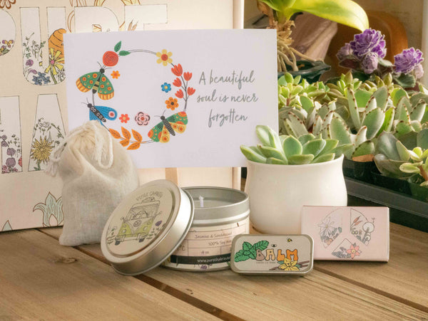 A beautiful soul is never forgotten Succulent Gift Box with candle, custom matches, lavender sachet and lip balm, in front of a decorative gift box