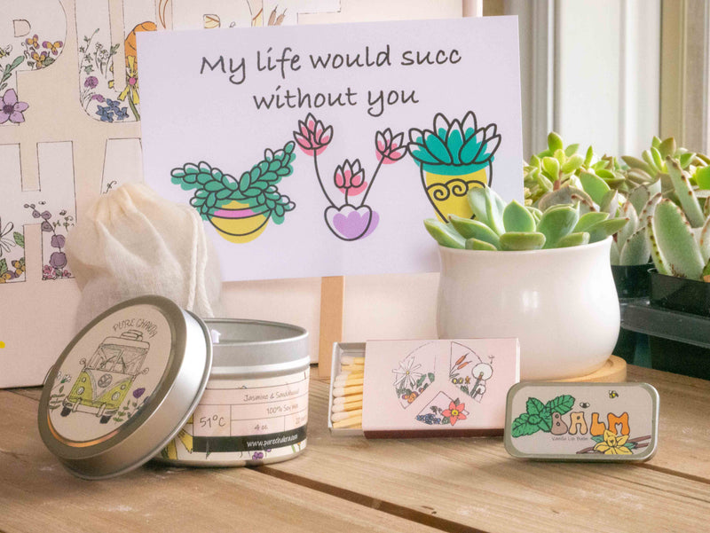 My life would succ without you Succulent Gift Box with candle, custom matches, lavender sachet and lip balm, in front of a decorative gift box