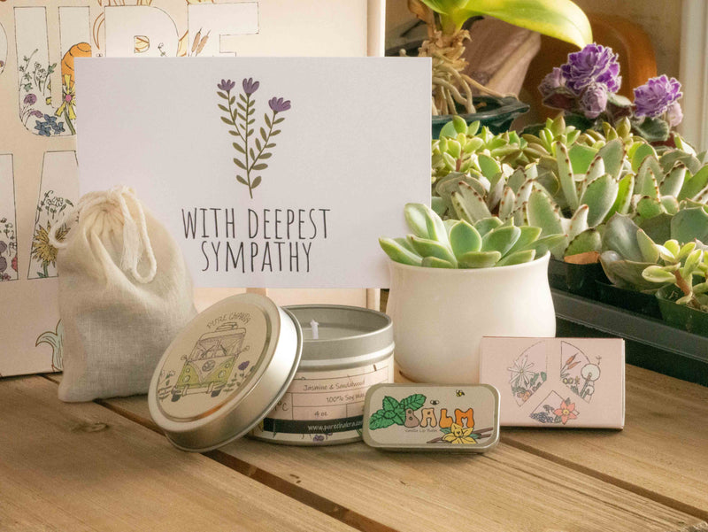 With deepest sympathy Succulent Gift Box with candle, custom matches, lavender sachet and lip balm, in front of a decorative gift box