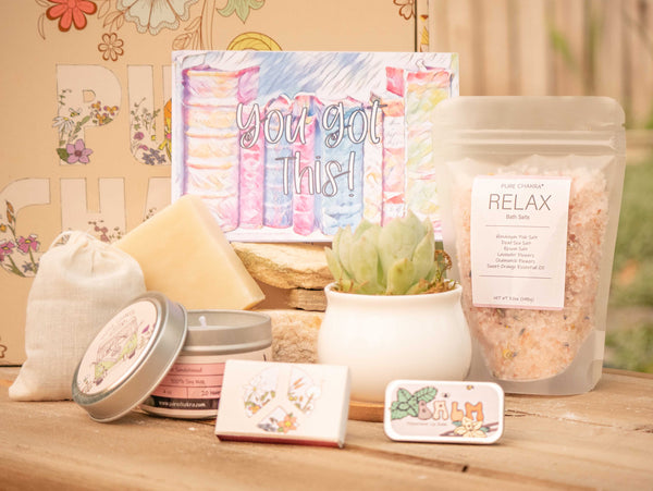 You got this! Succulent Gift Box with relax bath salt, natural soap, candle, custom matches, lavender sachet and lip balm, in front of a decorative gift box