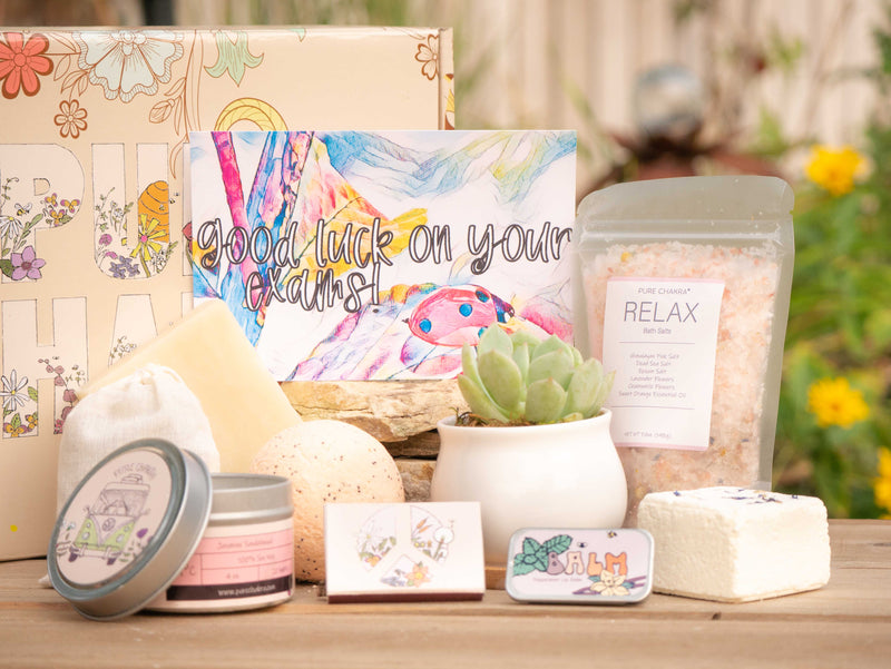 Good luck on your exams Succulent Gift Box with relax bath salt, natural soap, bath bomb, shower steamer, candle, custom matches, lavender sachet and lip balm, in front of a decorative gift box