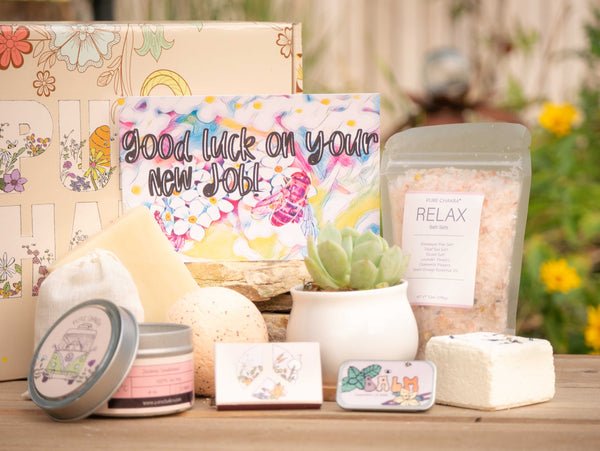 Good luck on your new job! Succulent Gift Box with relax bath salt, natural soap, bath bomb, shower steamer, candle, custom matches, lavender sachet and lip balm, in front of a decorative gift box
