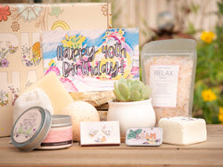 Happy 40th Birthday Succulent Gift Box with relax bath salt, natural soap, bath bomb, shower steamer, candle, custom matches, lavender sachet and lip balm, in front of a decorative gift box