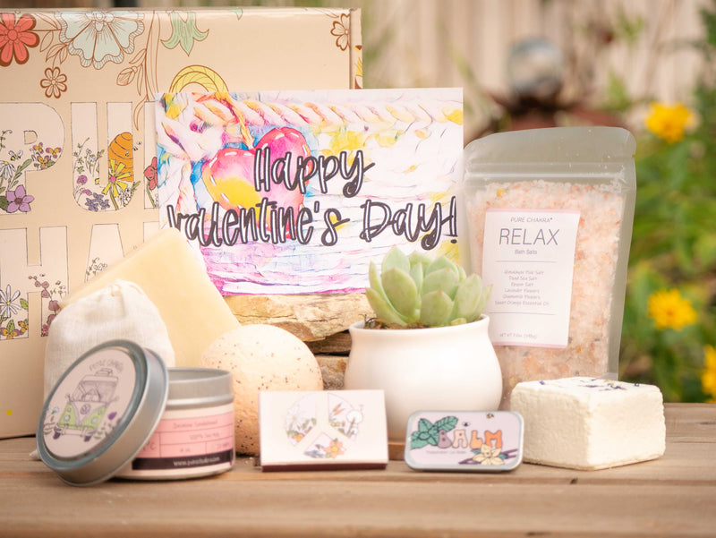 Happy Valentine's Day! Succulent Gift Box with relax bath salt, natural soap, bath bomb, shower steamer, candle, custom matches, lavender satchet and lip balm, in front of a decorative gift box