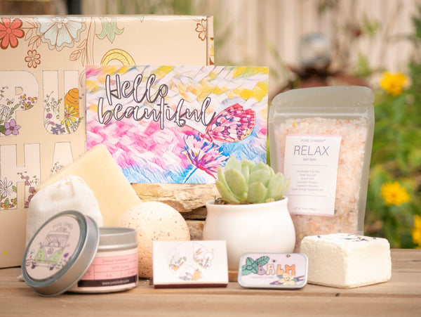 Hello beautiful Succulent Gift Box with relax bath salt, natural soap, bath bomb, shower steamer, candle, custom matches, lavender satchet and lip balm, in front of a decorative gift box