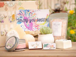 Sending you sunshine Succulent Gift Box with relax bath salt, natural soap, bath bomb, shower steamer, candle, custom matches, lavender satchet and lip balm, in front of a decorative gift box