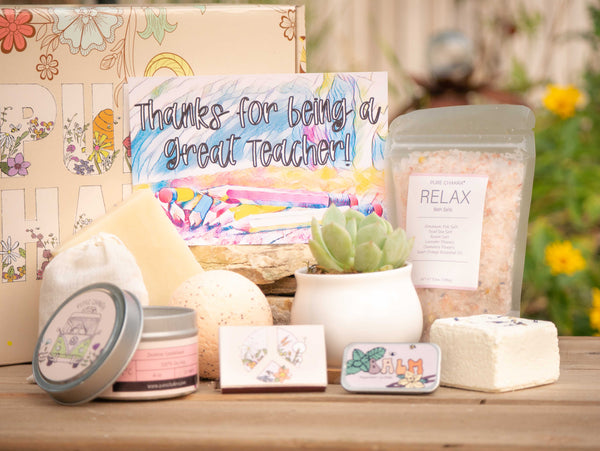 Thanks for being a great teaecher! Succulent Gift Box with relax bath salt, natural soap, bath bomb, shower steamer, candle, custom matches, lavender sachet and lip balm, in front of a decorative gift box