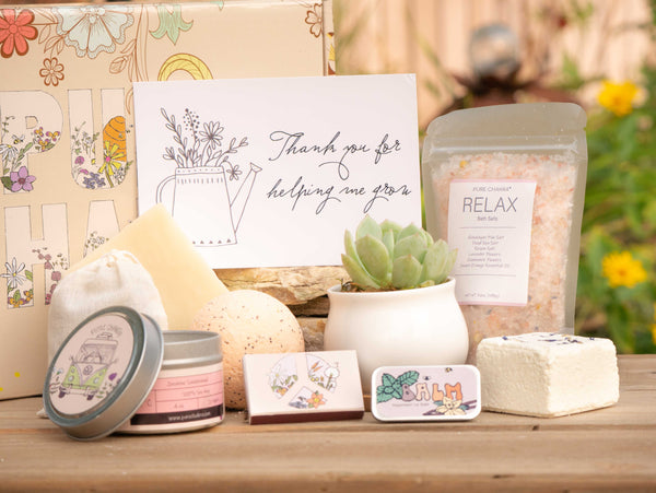 Thank you for helping me grow Succulent Gift Box with relax bath salt, natural soap, bath bomb, shower steamer, candle, custom matches, lavender sachet and lip balm, in front of a decorative gift box
