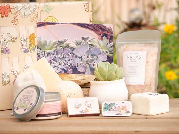 Wishing you  a speedy recovery Succulent Gift Box with relax bath salt, natural soap, bath bomb, shower steamer, candle, custom matches, lavender sachet and lip balm, in front of a decorative gift box