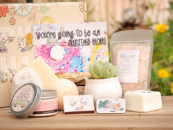 You're going ot be an amazing mom! Succulent Gift Box with relax bath salt, natural soap, bath bomb, shower steamer, candle, custom matches, lavender satchet and lip balm, in front of a decorative gift box