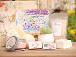 The memories of a beloved cat remains in our hearts & souls forever Succulent Gift Box with relax bath salt, natural soap, bath bomb, shower steamer, candle, custom matches, lavender sachet and lip balm, in front of a decorative gift box